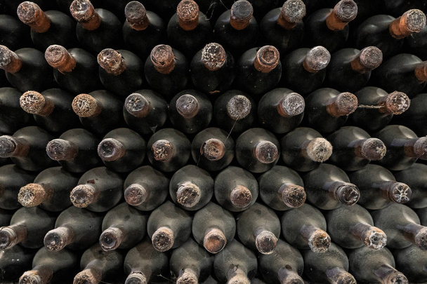 Wine bottles pattern stacked in winery - Photo, Image