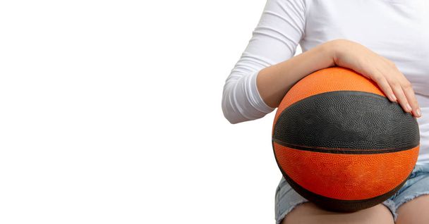 young teenager with a basketball on the white background - 写真・画像