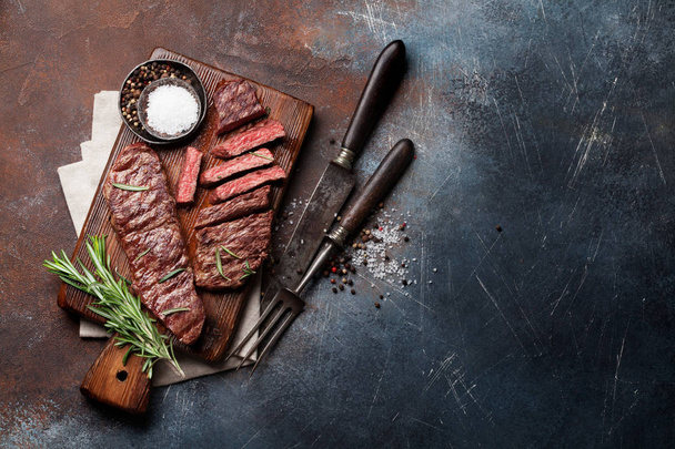 Top blade or denver grilled steak over cutting board. Top view with copy space - Photo, Image