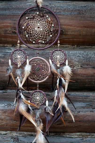 Traditional indian talisman dreamcatcher on wooden background  - Photo, Image