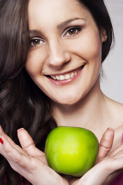 Young woman with an apple - Foto, Imagen