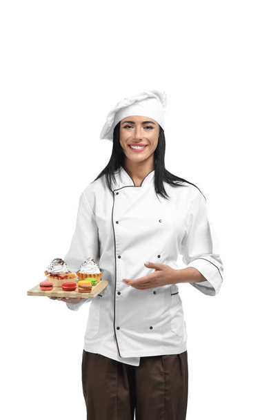 Young confectioner in professional clothes liking her job. - Foto, imagen