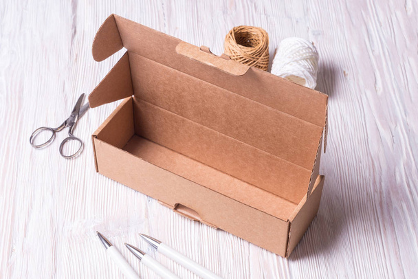 Cardboard box on wooden background - Фото, изображение