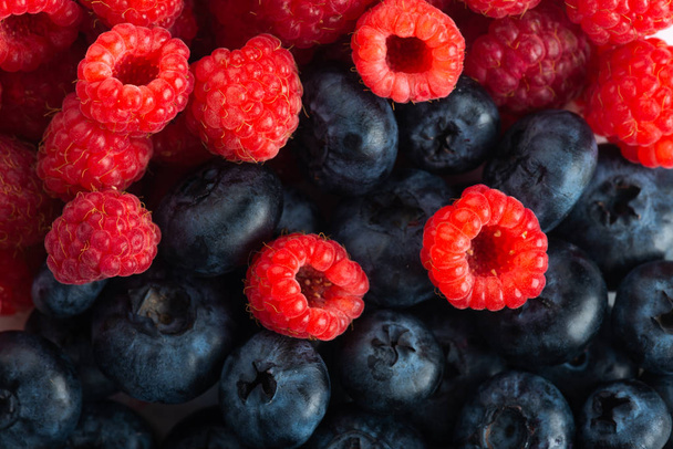Fresh blueberries and raspberries, close up - Foto, Imagen