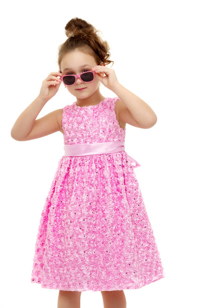 Little girl in sunglasses. - 写真・画像