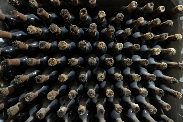 Pattern of wine bottles stacked in a wine cellar - Photo, Image