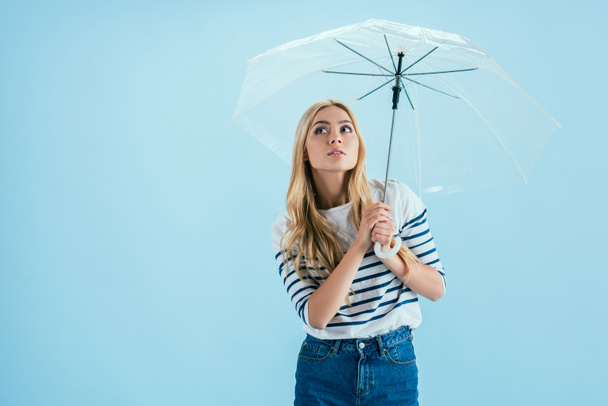 Sensual joven posando bajo paraguas sobre fondo azul
 - Foto, Imagen