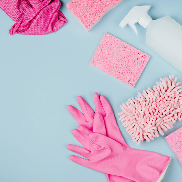 Detergents and cleaning accessories in pink color, cleaning service concept - Photo, image