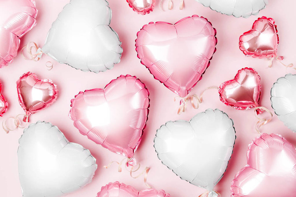 Air balloons of heart shaped foil on pastel pink background, Valentines day concept - Fotografie, Obrázek