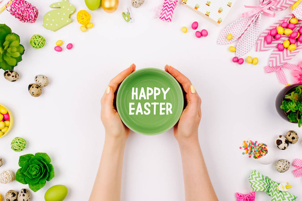 Woman holding dish on spring decoration background, Easter concept - Foto, afbeelding
