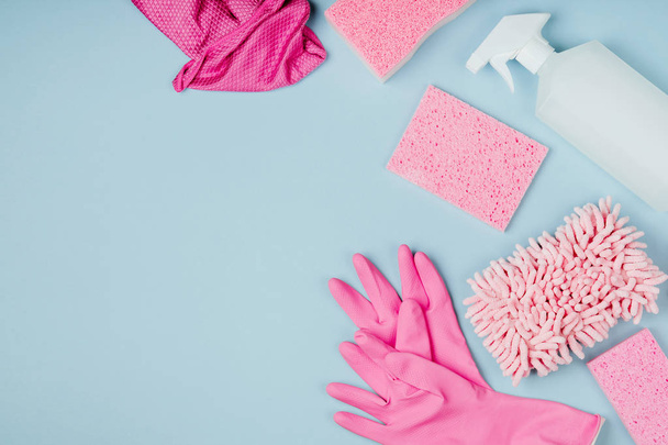 Detergents and cleaning accessories in pink color, cleaning service concept - Фото, зображення