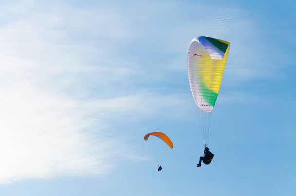 Paragliders flying in the blue sky at daytime  - Fotó, kép