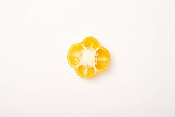Studio shot of cut yellow bell pepper on white background - Foto, Imagem