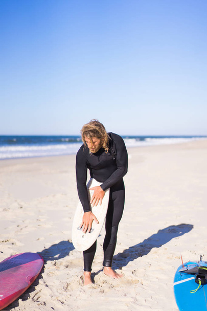 surfer with flippers and a bodyboard in a hydro suit on the ocean shore - Photo, image