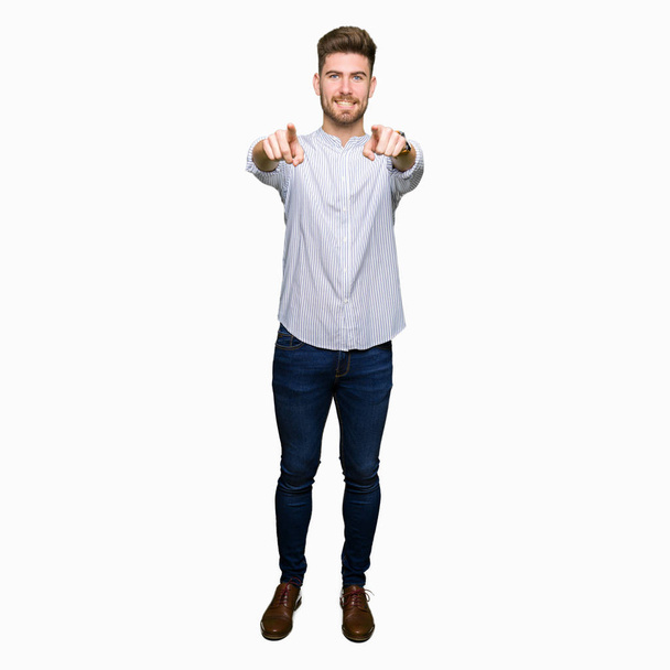 Young handsome man Pointing to you and the camera with fingers, smiling positive and cheerful - Photo, Image