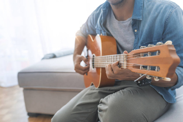 Close up of man playing guitar - Foto, imagen