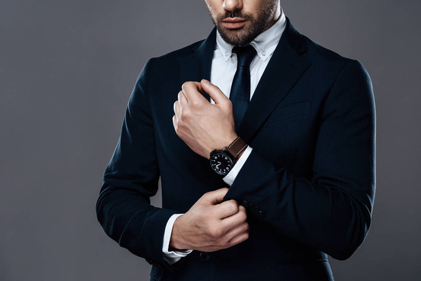 Close-up handsome and successful man in an expensive suit. He is in a white shirt with a tie. - Foto, Imagen