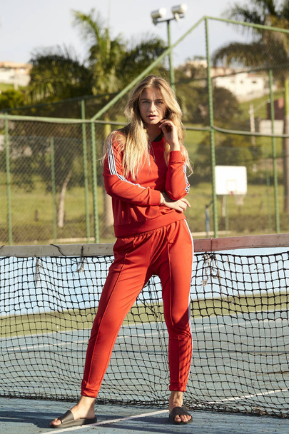 Portrait of sporty girl in red tracksuit - Fotó, kép