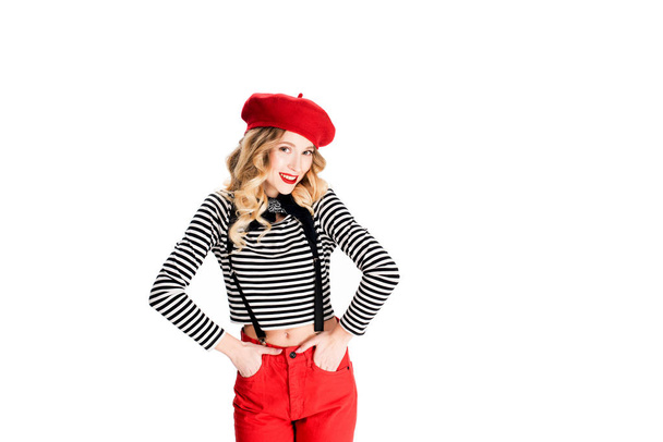 pretty woman in red beret and holding hands in pockets isolated on white - Valokuva, kuva