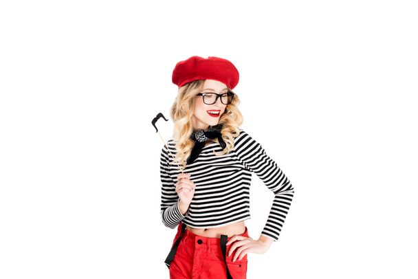 attractive blonde woman in glasses holding fake mustache on stick isolated on white  - Фото, изображение