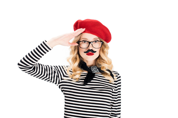 serious woman in glasses and red beret with fake mustache isolated on white  - Foto, afbeelding