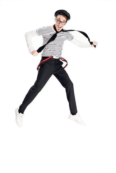 cheerful man in black beret smiling while jumping isolated on white  - Фото, зображення
