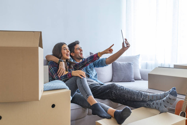 Young couple taking selfie in new home  - Fotó, kép