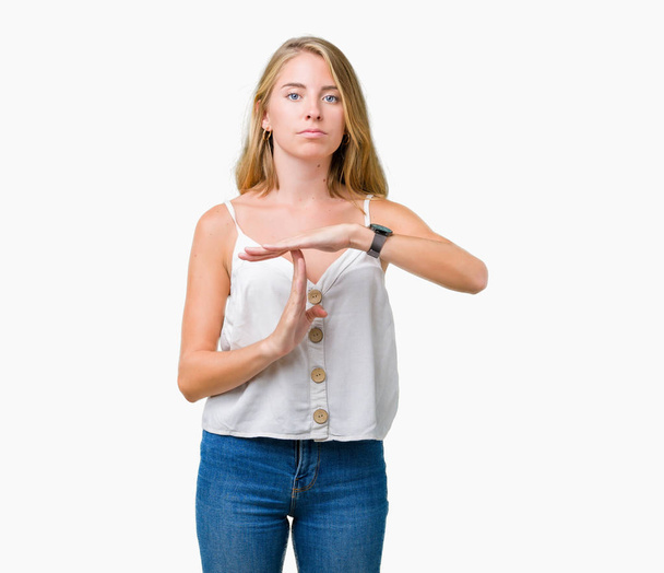 Beautiful young woman over isolated background Doing time out gesture with hands, frustrated and serious face - Φωτογραφία, εικόνα