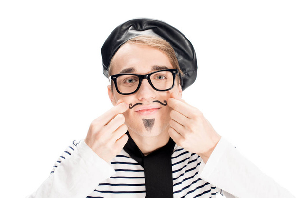 french man in black beret and scarf touching mustache isolated on white  - 写真・画像