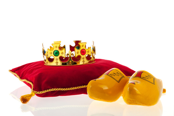 Golden crown on velvet pillow with Dutch wooden clogs - Valokuva, kuva