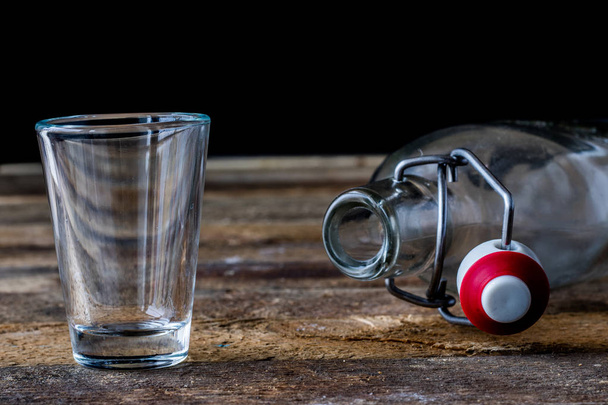 Glass dishes on a wooden table. Black background. - Photo, Image