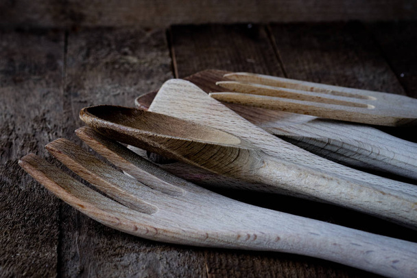 Wooden kitchen utensils on the kitchen table. - Fotó, kép