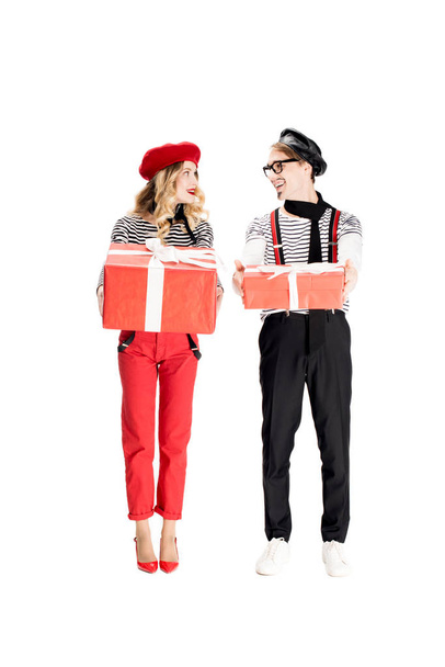 french man and attractive woman looking at each other while holding gift boxes isolated on white  - Photo, Image