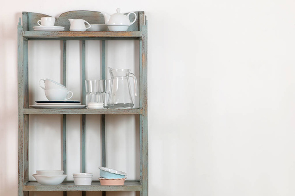 Vintage shelf with kitchenware on a white wall background. antique shelf. interior - Photo, Image