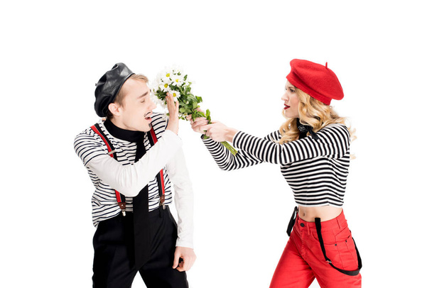 man and woman in red beret fighting with flowers isolated on white  - 写真・画像