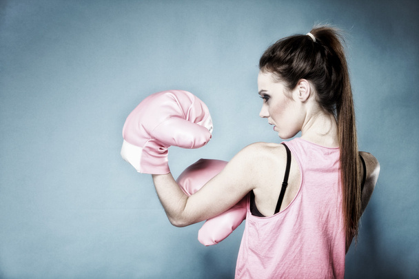 Female boxer model with big fun pink gloves - Fotó, kép