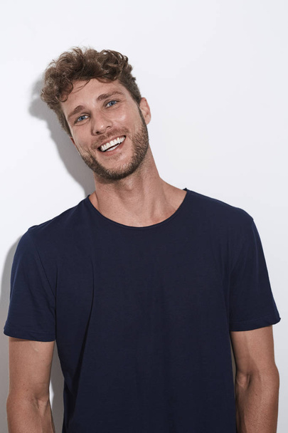 Laughing handsome guy in blue t-shirt - Fotó, kép