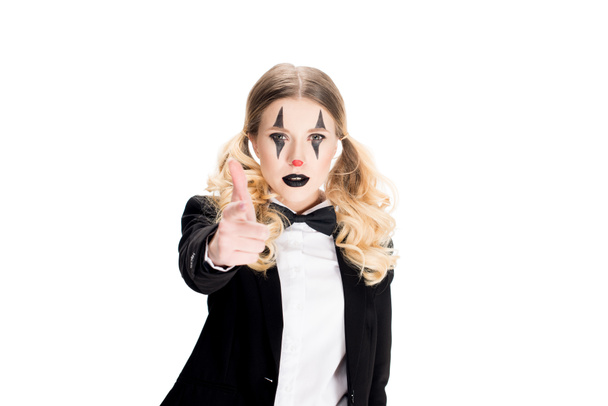 serious female clown in suit looking at camera and pointing with finger isolated on white  - Fotó, kép