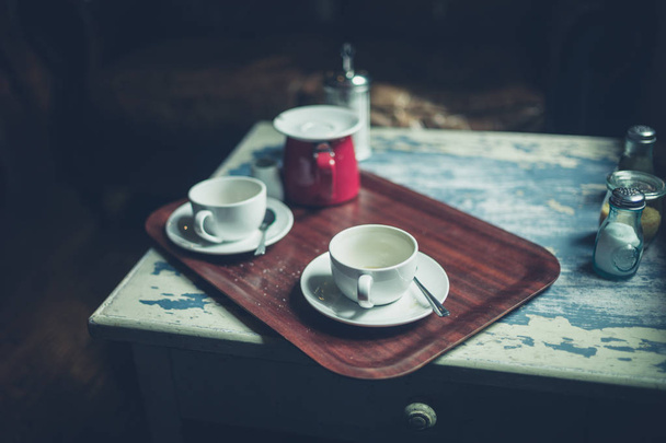 Two empty cups of coffee on a table in a cafe - 写真・画像
