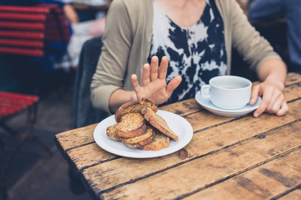 Young woman on gluten free diet is saying no thanks to toast in a cafe - Zdjęcie, obraz