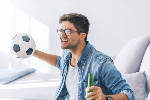 Portrait of man watching football at home - Zdjęcie, obraz