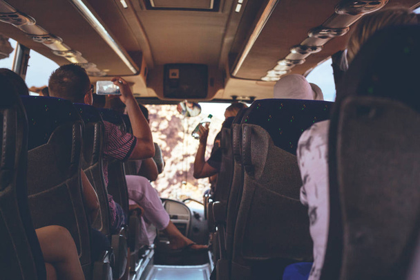 The tourist bus interior with people sitting. Back view. - Φωτογραφία, εικόνα
