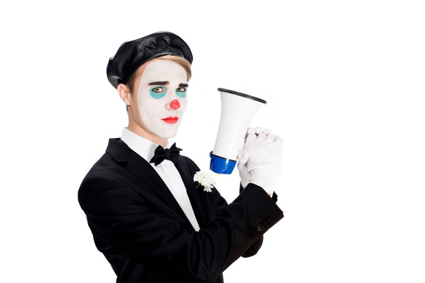 serious clown in suit and black beret holding megaphone isolated on white  - Photo, Image