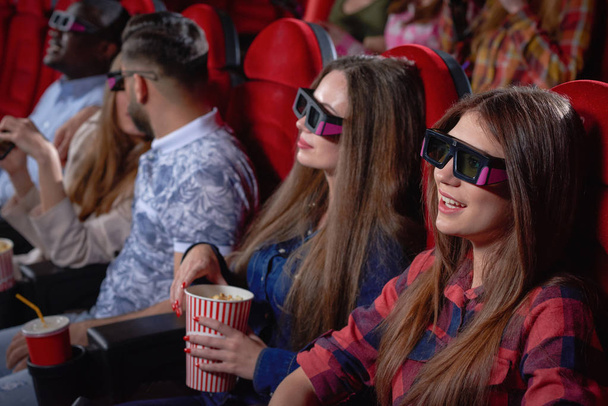Pretty teenagers enjoying comedy in cinema. - Fotoğraf, Görsel