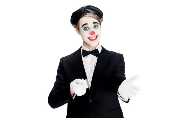 cheerful clown smiling while holding credit card isolated on white  - Foto, Imagem