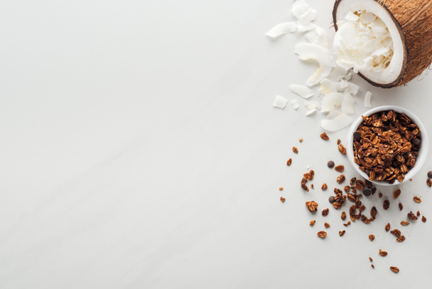 top view of granola and coconut with flakes on white background with copy space - Photo, Image
