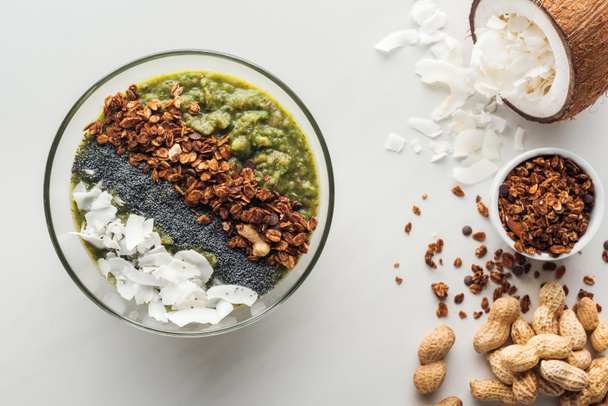 白い背景の上の食材と新鮮な緑のスムージー ボウルのトップ ビュー - 写真・画像