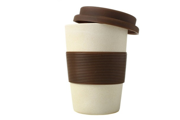 One beige plastic disposable cup with silicone isolated on white. - Photo, Image