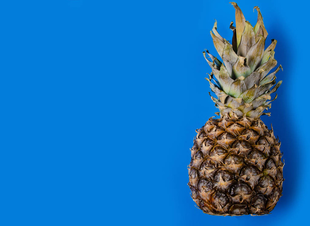 Pineapple fruit on blue background - Valokuva, kuva