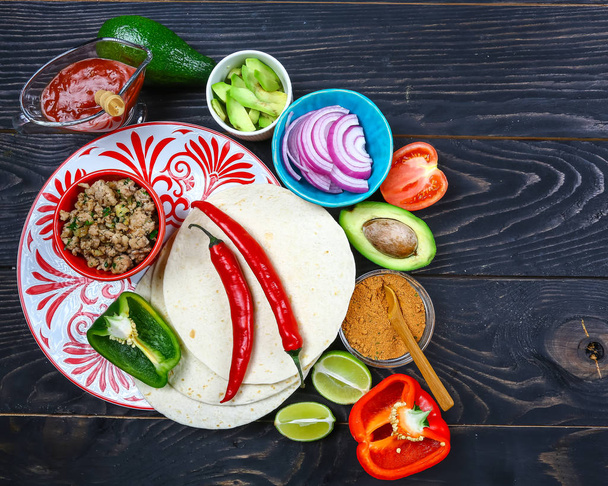A plate of delicious tacos and food ingredients. Mexican cooking recipe. - Fotoğraf, Görsel